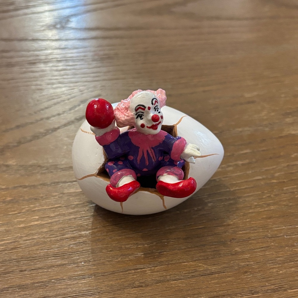 Playful Clown Emerging from Egg